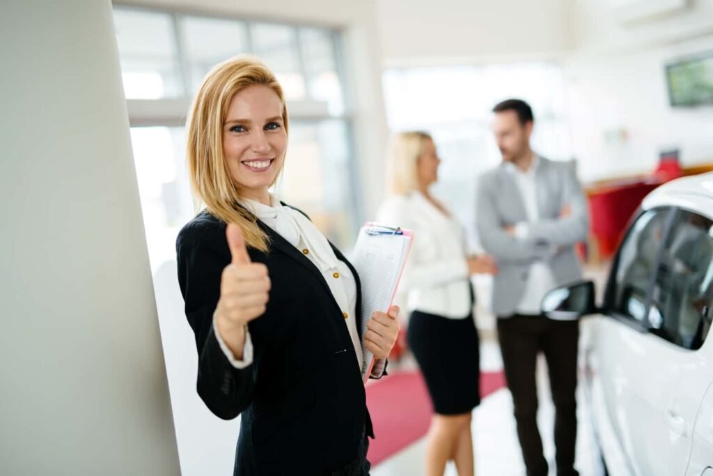 Happy customer giving a thumbs up at a car dealership